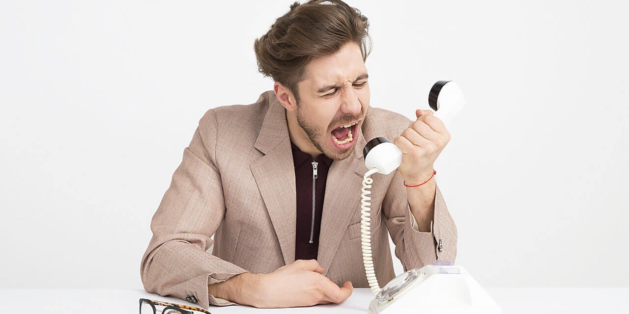 man-screaming-down-the-phone